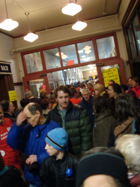 Long Lines and man making the sign of the cross